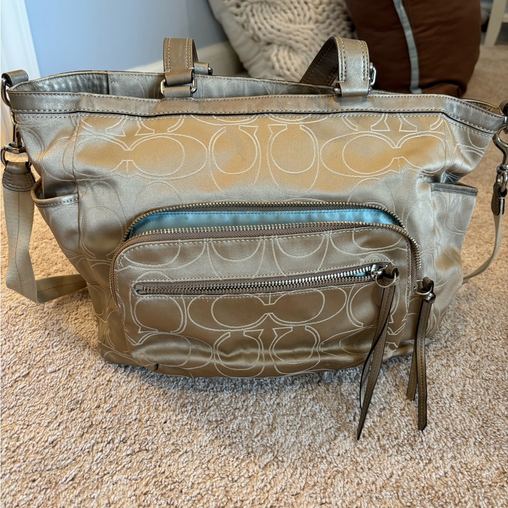 Coach diaper bag. Comes with messenger strap and changing pad.
